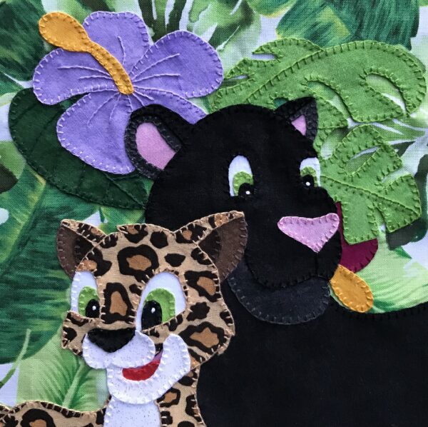 A felt applique of a leopards and a tiger.