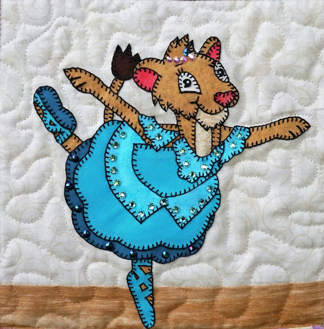 A quilt with a Dance - Lioness in a blue dress.