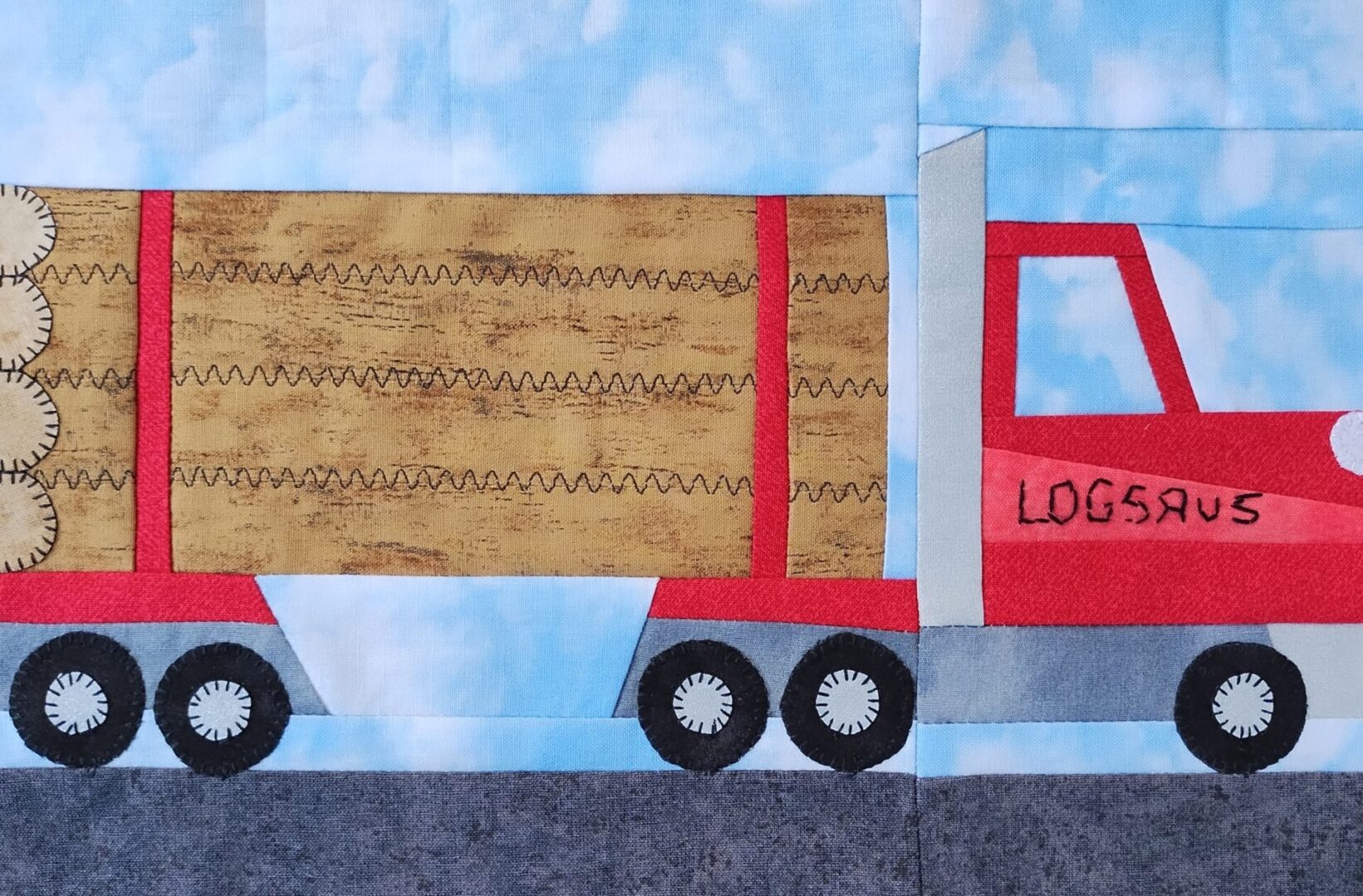 A quilt with a Logging Truck carrying logs.