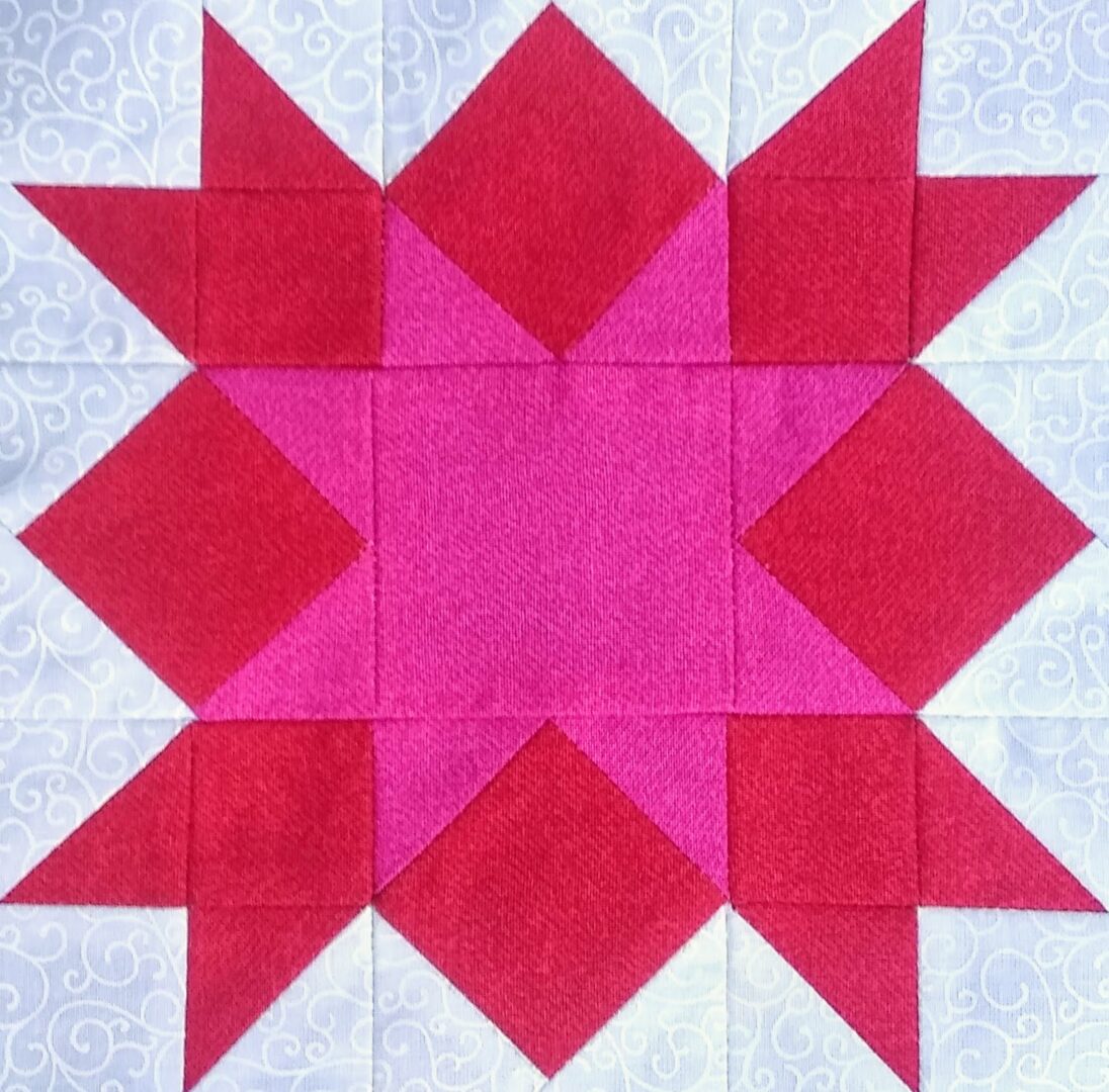 A quilt block with Love in the Mist Stars.