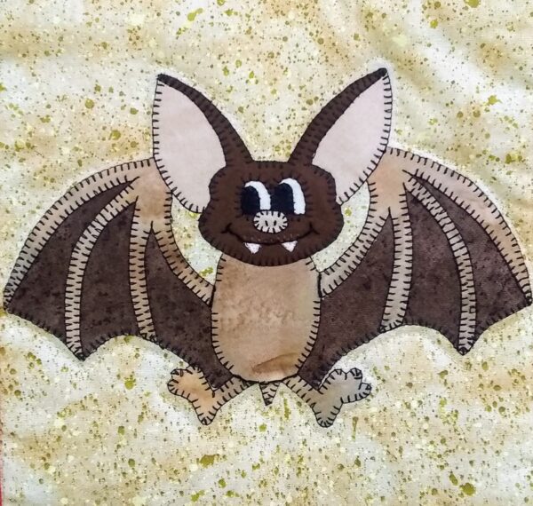 A quilt block with a Mexican Free Tailed Bat on it.