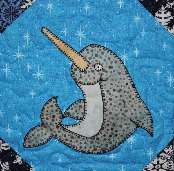 A quilt with Narwhal on it.