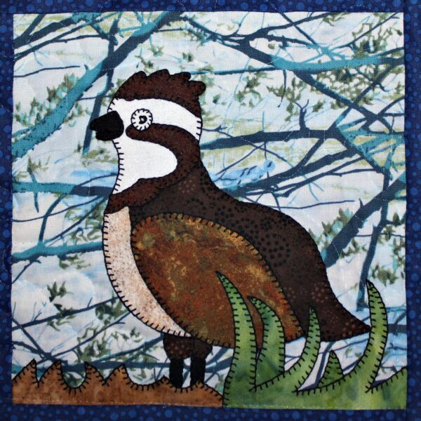 A quilt with a Northern Grouse on it.