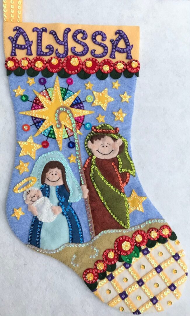 A Oh Holy Night Stocking with an image of the nativity scene.