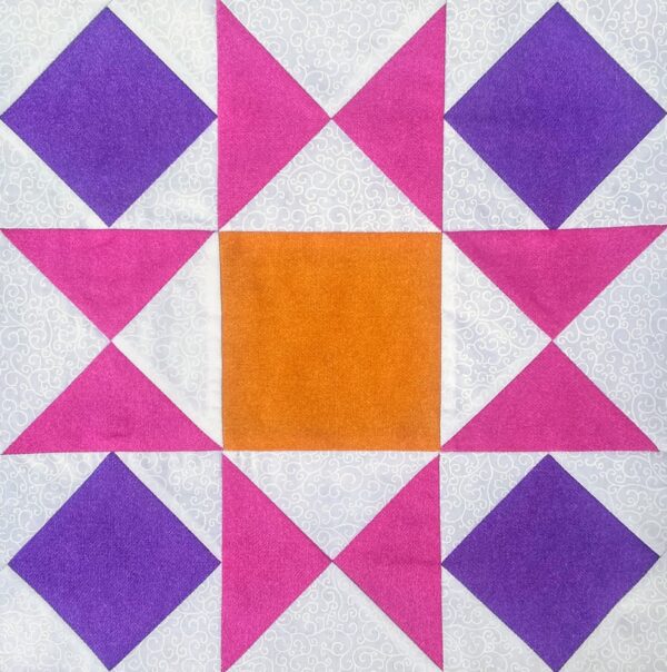 An Ornate Star quilt block with purple and orange squares.