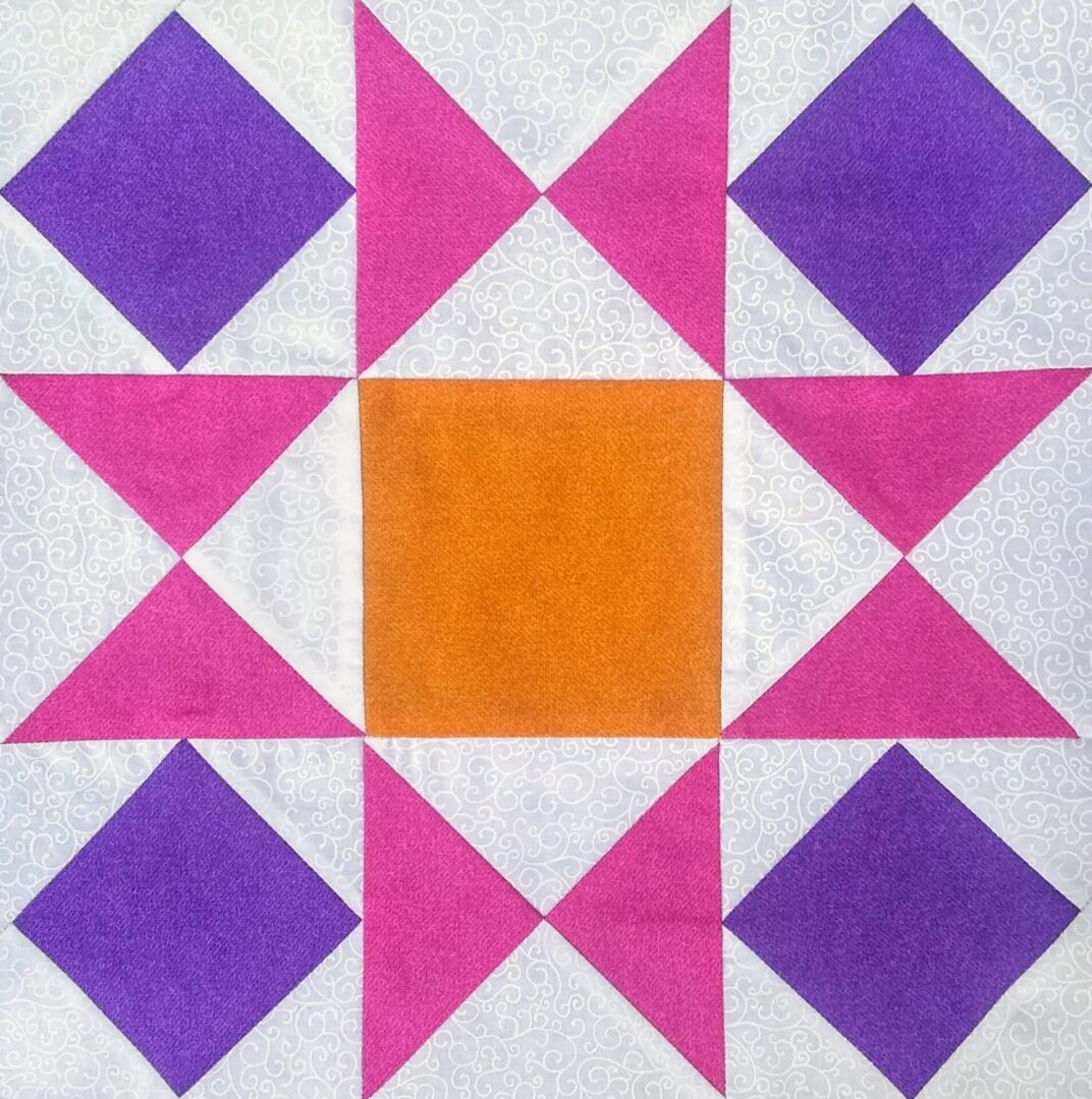 An Ornate Star quilt block with purple and orange squares.