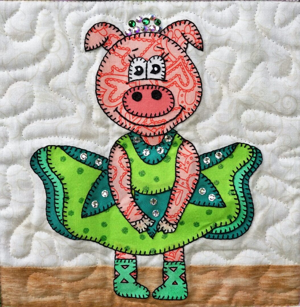 A quilt with Dance - Piggy in a green dress.