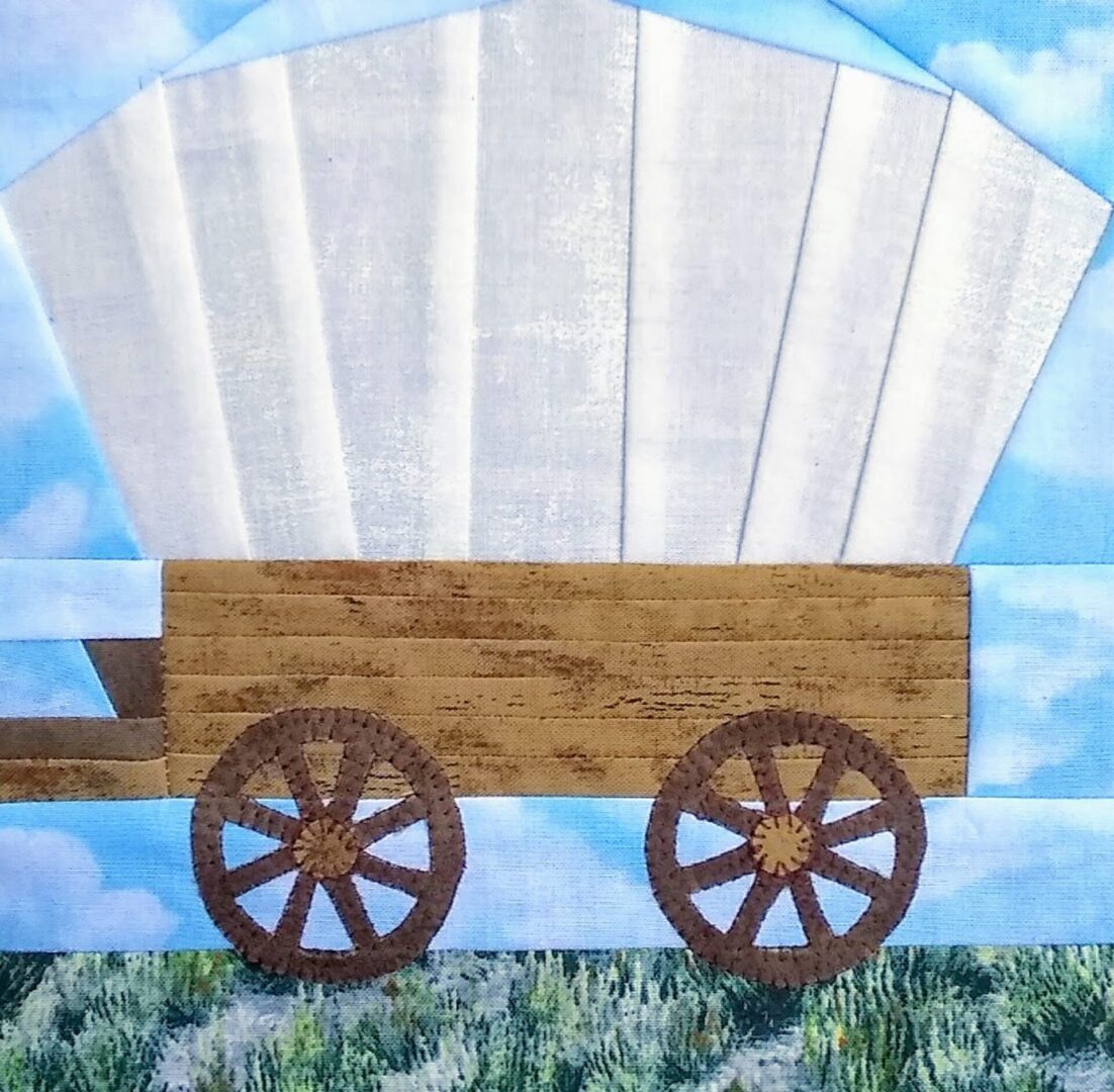A quilt block with a Prairie Schooner Wagon on it.