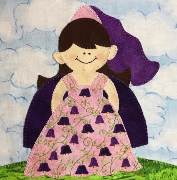 A girl in a Fairy Tale - Princess dress is standing on a hill.