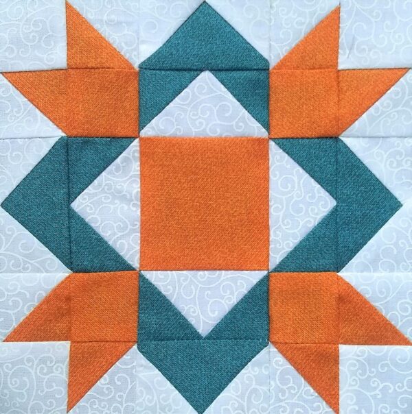 A Royal Star quilt block with orange and blue squares.