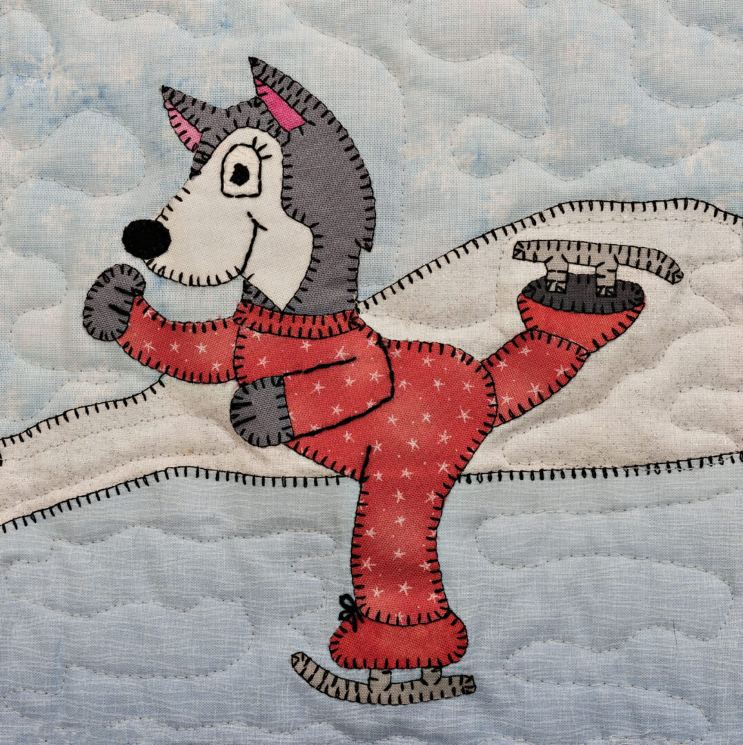 A quilted wall hanging with a Husky - Skater.