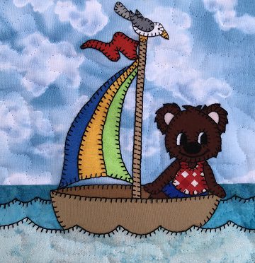 A Sailor Bear in a sailboat on the ocean.