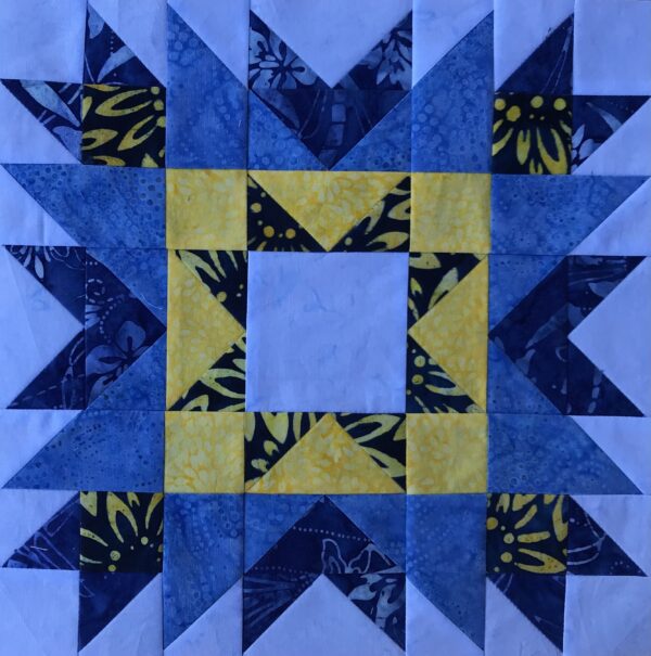 A blue and yellow San Diego star quilt block.