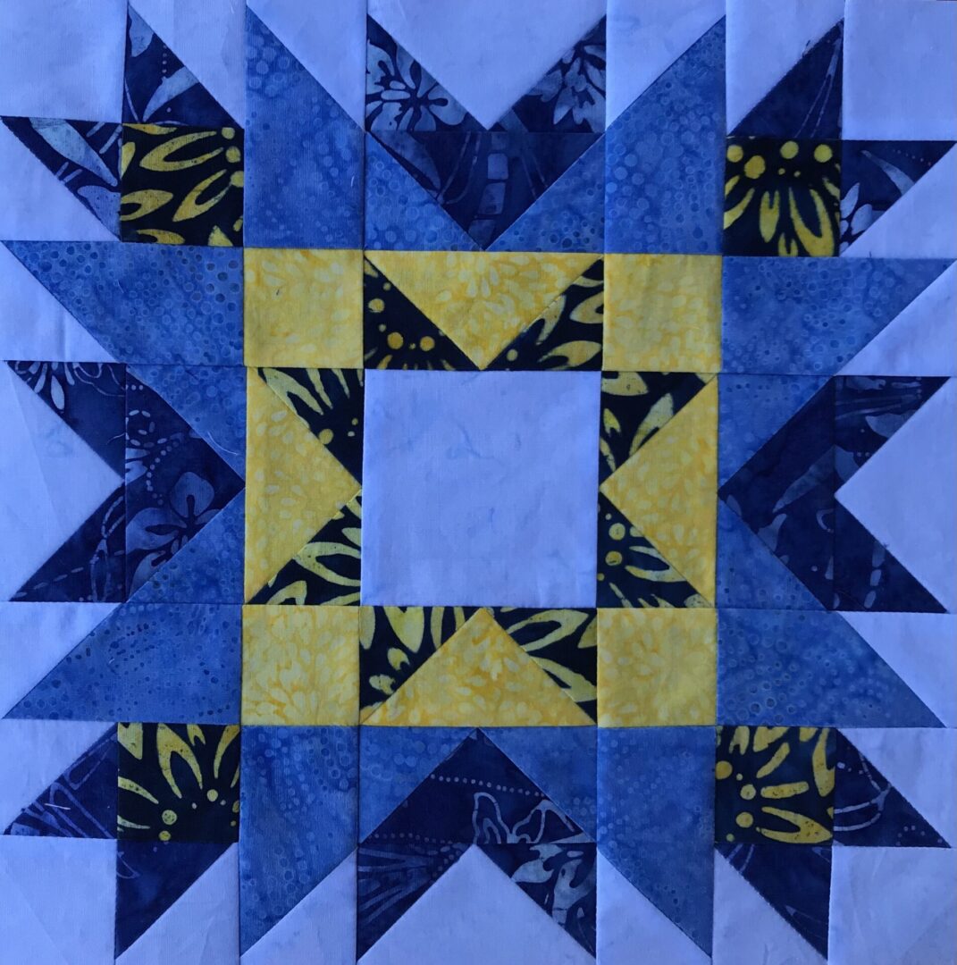 A blue and yellow San Diego star quilt block.