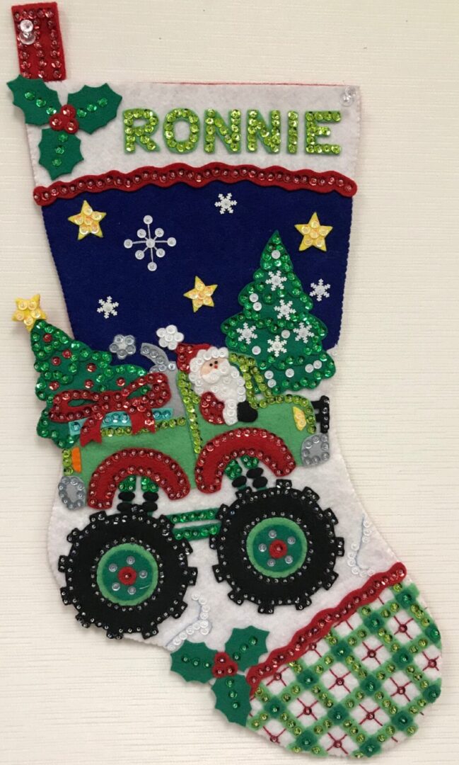 A Christmas stocking with Santa's Monster Truck Stocking on it.