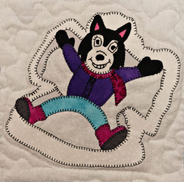 A Husky - Snow Angel appliqued on a pillow.