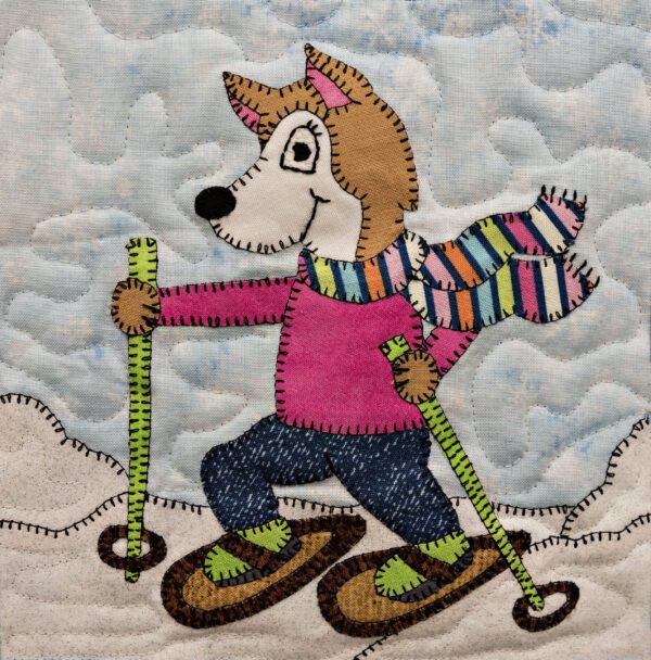 A Husky - Snowshoe on skis on a quilted wall hanging.