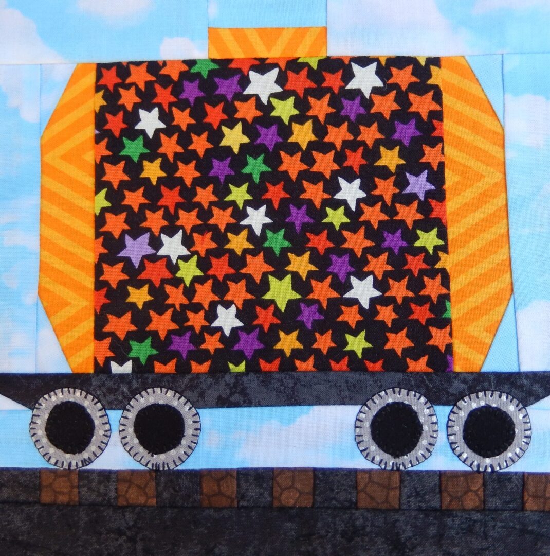 A quilt with a Tanker Car and stars on it.