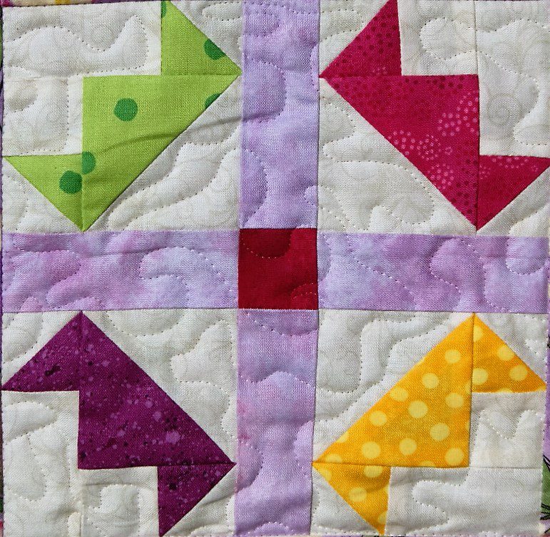 A close up of a Dance - Tiaras quilted block.