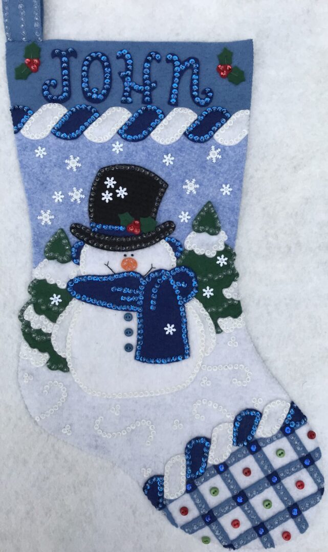 A Top Hat Snowman Stocking with a snowman on it.