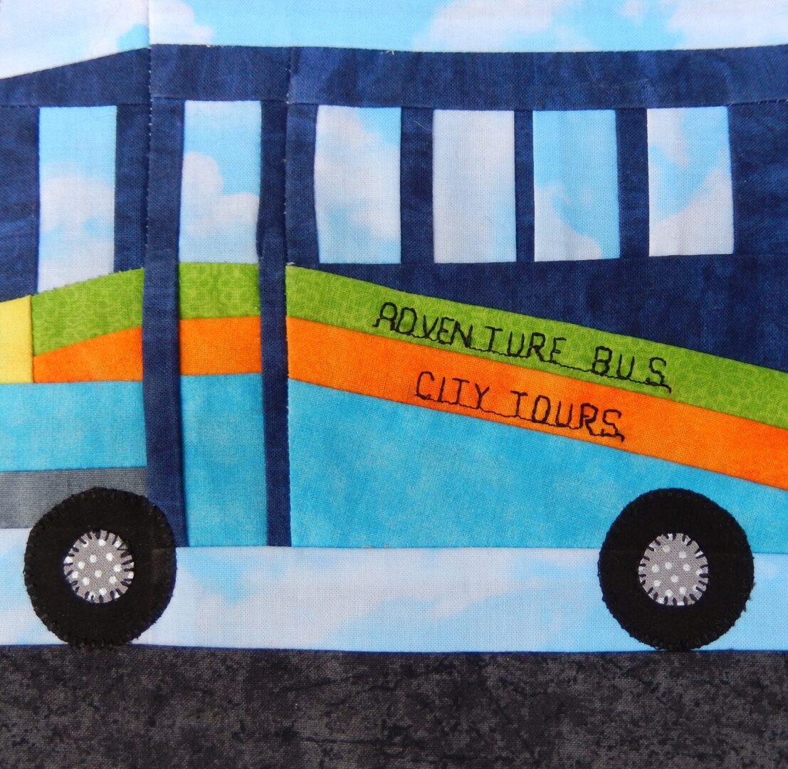 A quilt with a City Bus on it.
