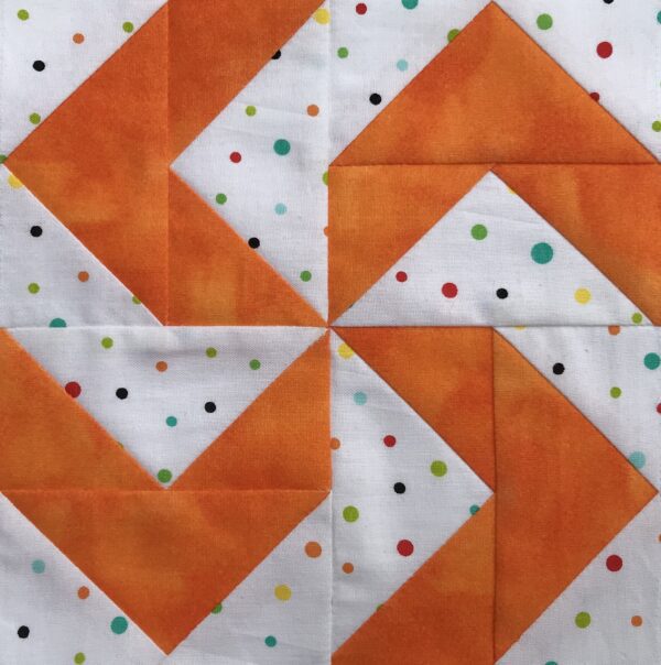 A Virginia Reel quilt block with polka dots.