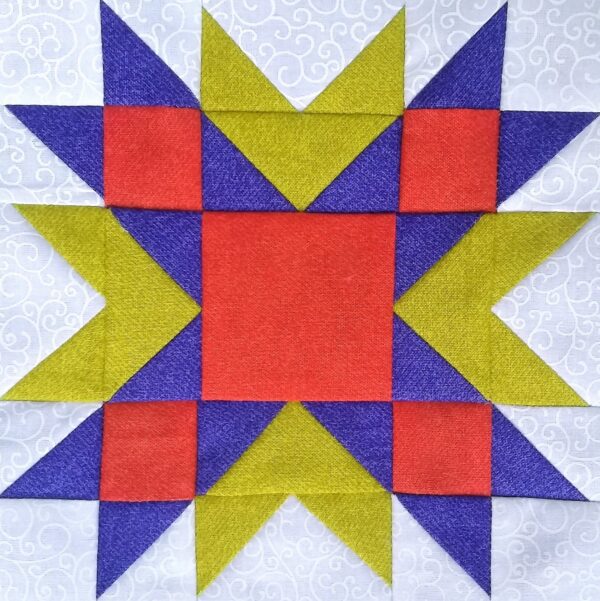 A Wyoming Star quilt block with red, yellow, and blue squares.