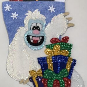 A Christmas stocking with a Yeti Gift Card Holder holding credit cards.