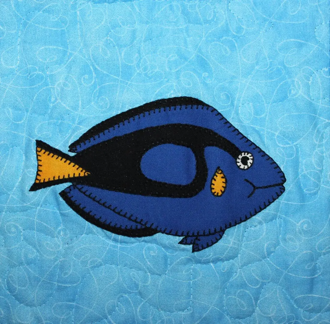 A Blue Tang fish on a blue background.
