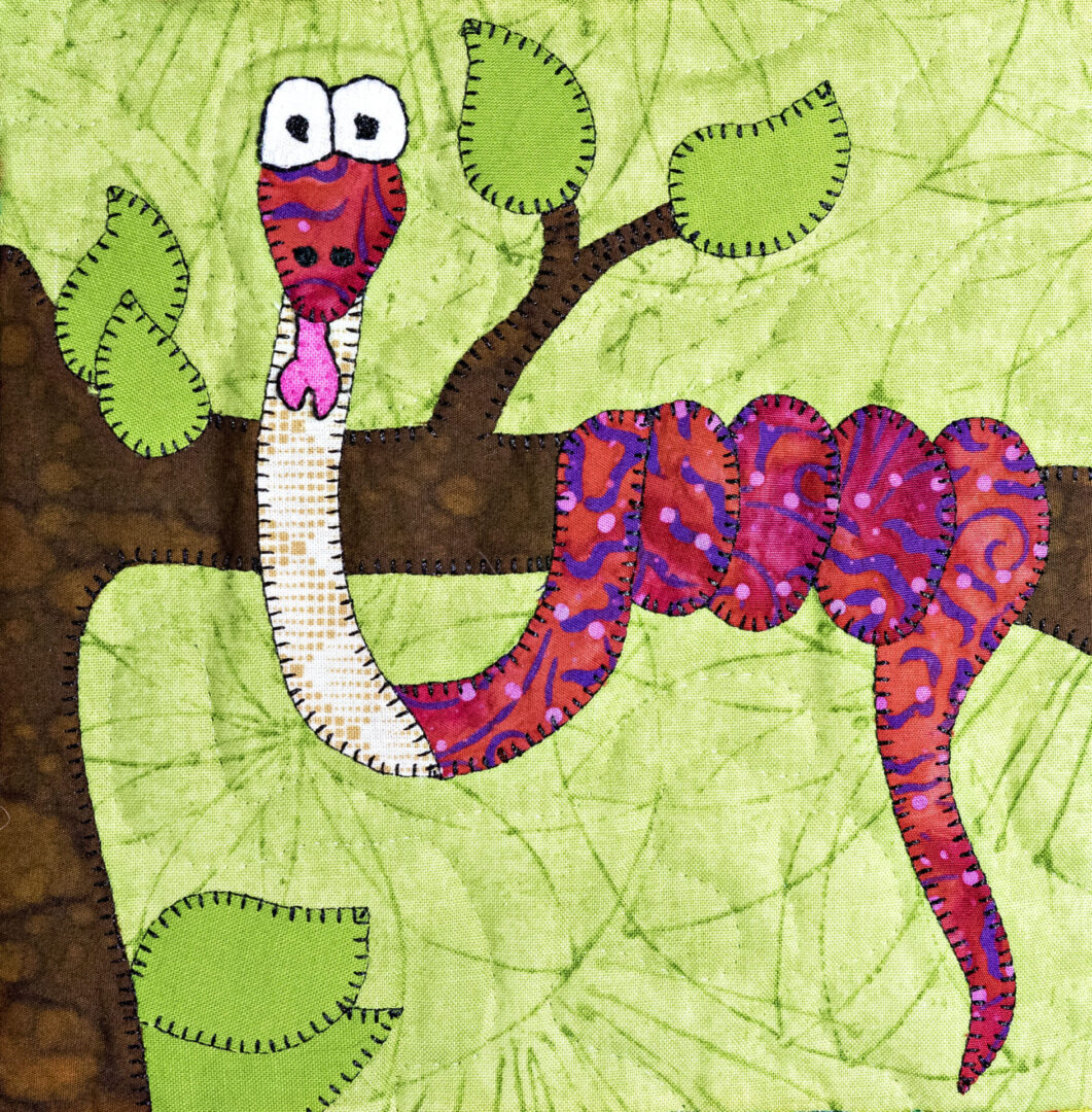 A Rainbow Boa quilt with a snake on a tree branch.