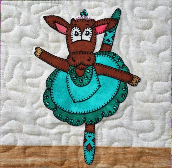 A quilted wall hanging with Dance - Cow.