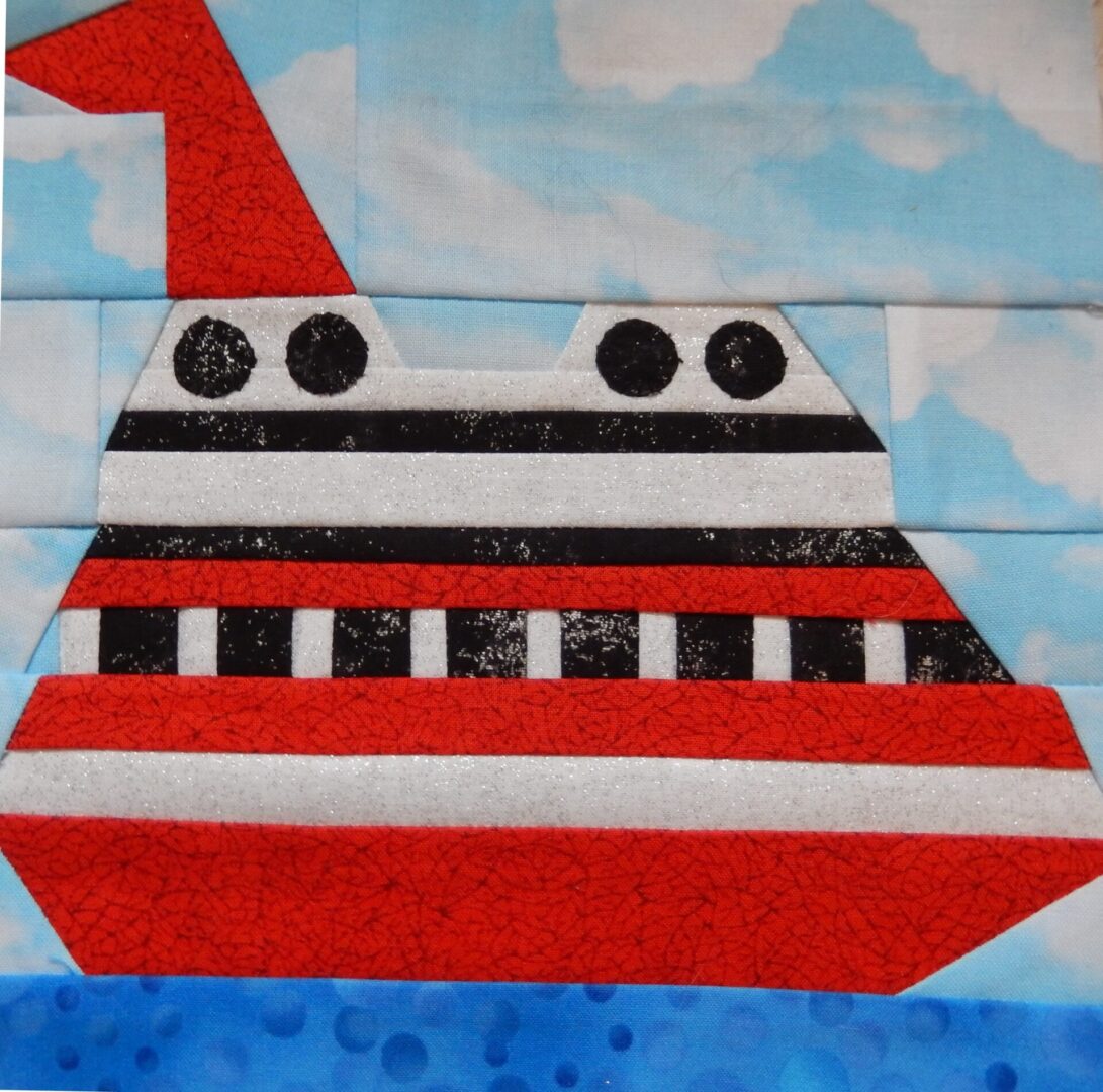 A red and white quilt block with a Cruise Ship on it.