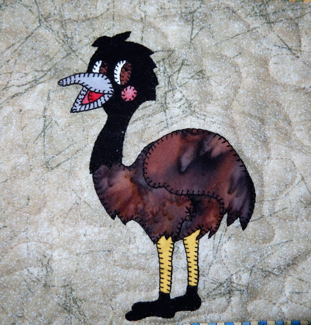 An emu appliqued on a piece of fabric.