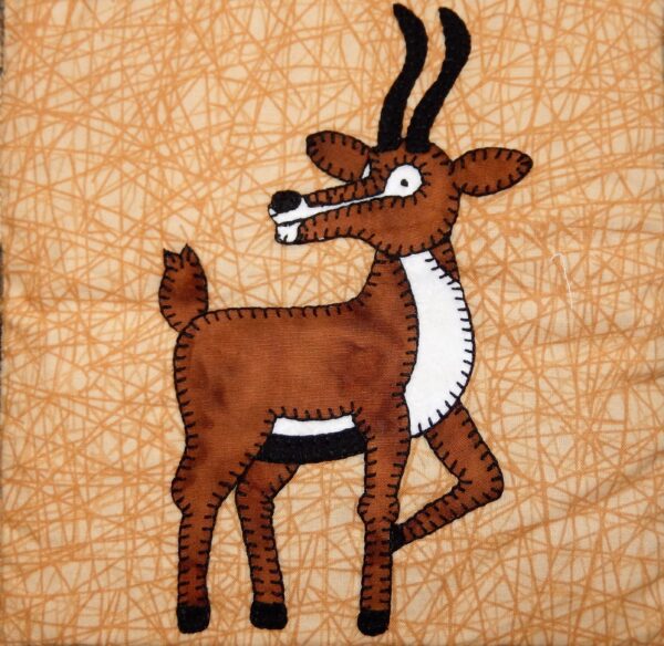 A Gazelle is embroidered on a brown background.