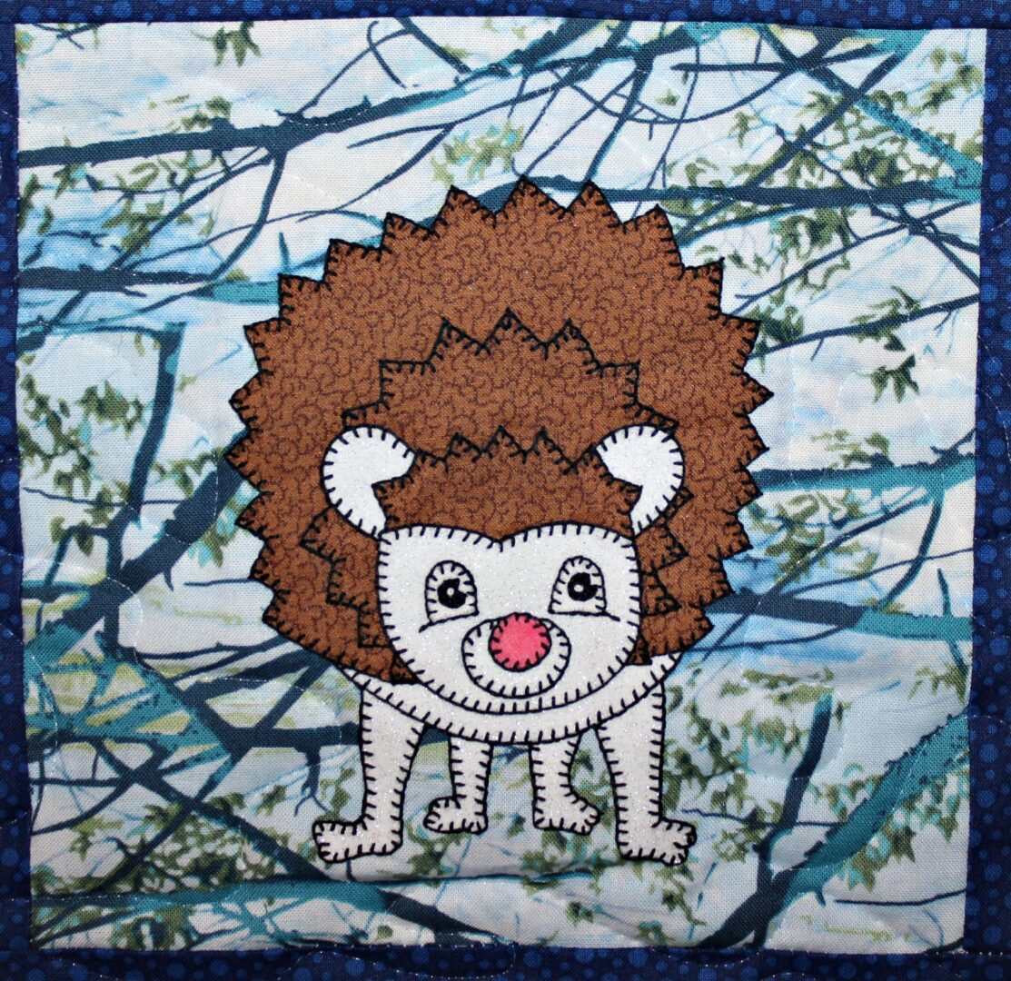 A Hedgehog appliqued on a blue background.