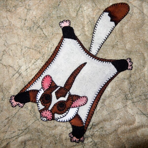 A white and brown Sugar Glider stuffed animal.