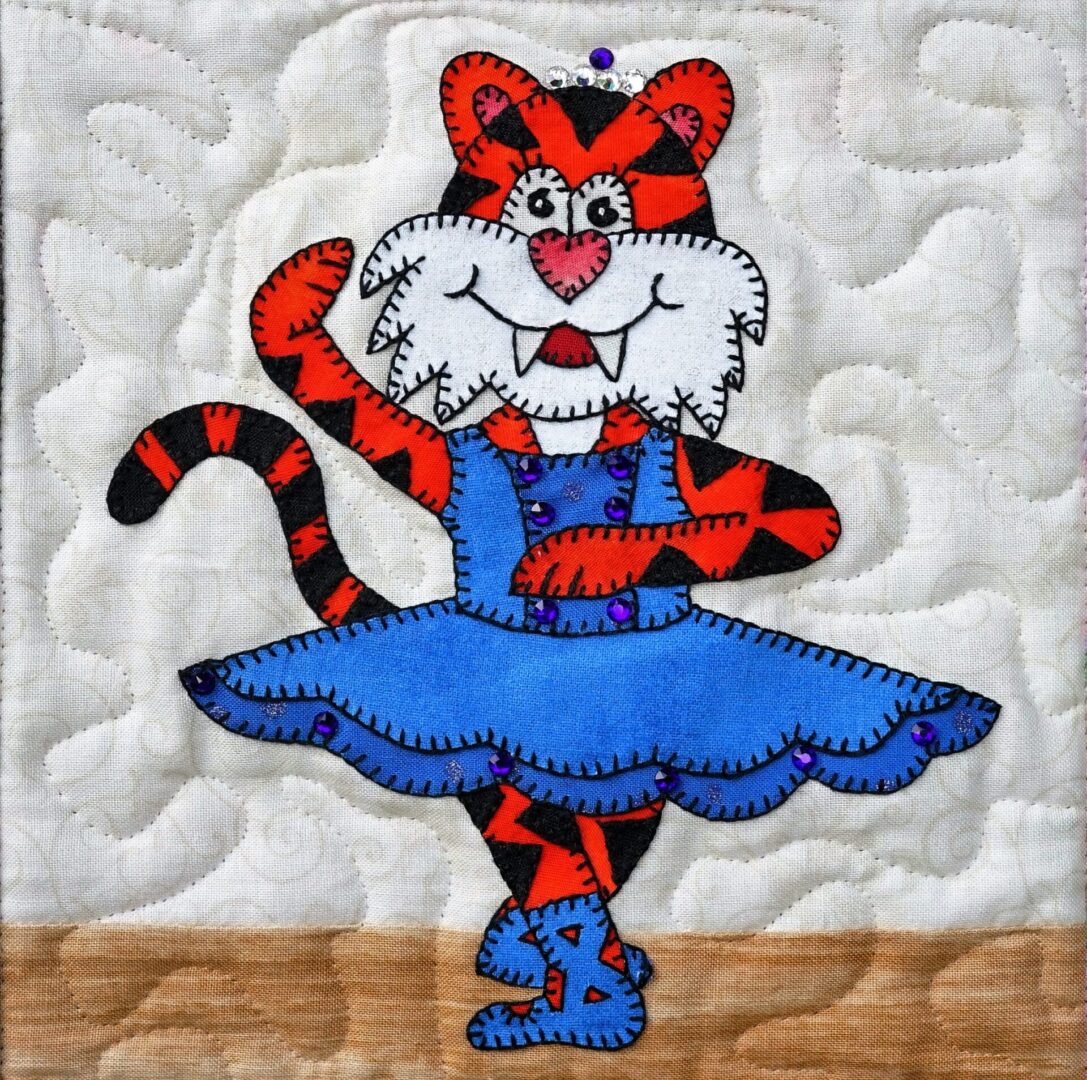 A quilted wall hanging with Dance - Tiger in a blue dress.