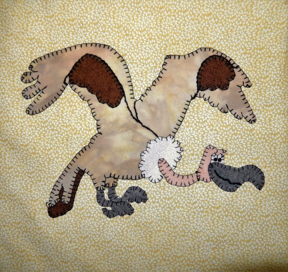 A Vulture appliqued on a yellow background.