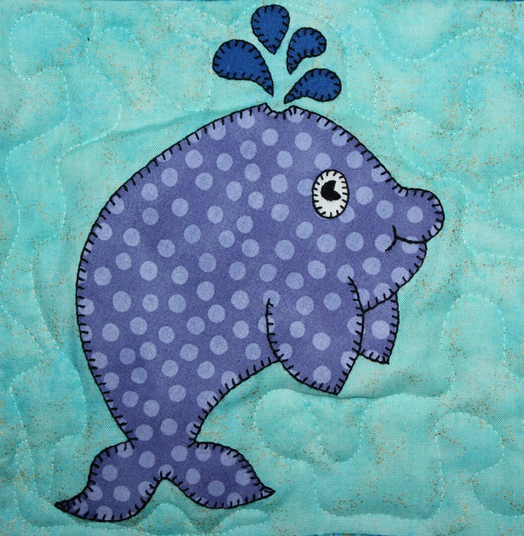 A blue Whale with polka dots on a blue background.